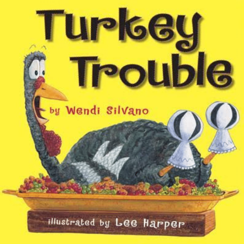 The cover of a children's book titled "Turkey Trouble" by Wendi Silvano, illustrated by Lee Harper. The cover features a cartoon turkey lying in a large dish filled with vegetables. The turkey has a worried expression and is holding two drumsticks with white frills on them. The background is bright yellow, and the title and author/illustrator names are prominently displayed.