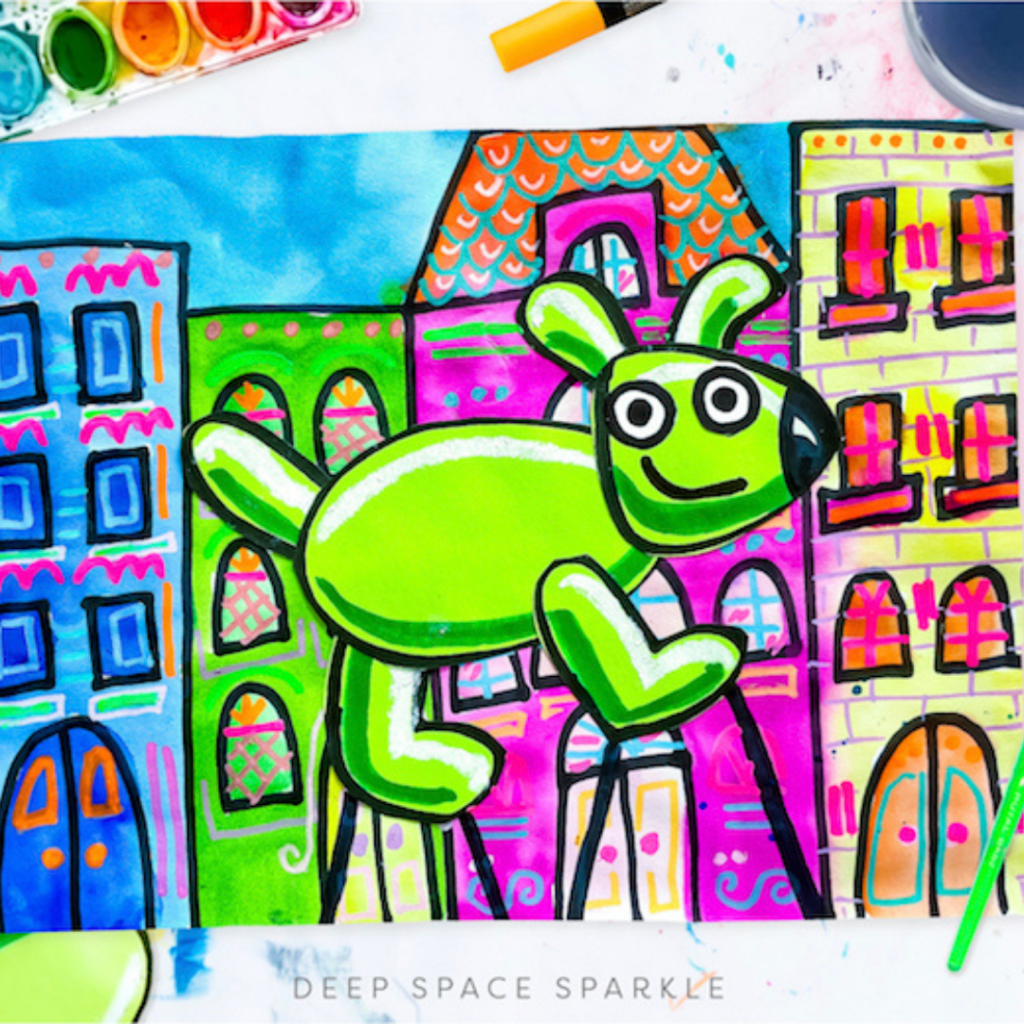 Colorful, whimsical drawing of a green dog-like creature with a black ear and a happy expression, set against a background of vibrant, multi-colored buildings with various patterns and designs. The artwork, created with markers and watercolors, exudes a joyful and creative urban scene.