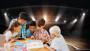 a group of children sitting around a table with a laptop